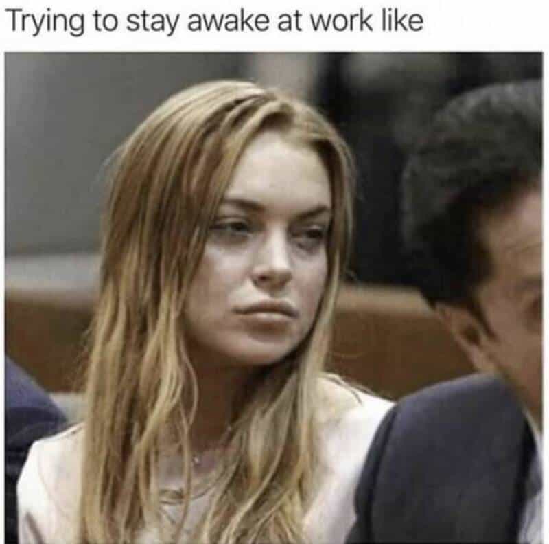 Trying to stay awake at work like a tired woman with a bored expression.