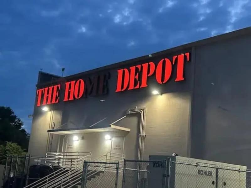 The Ho Depot sign on a building at dusk with a blue sky.