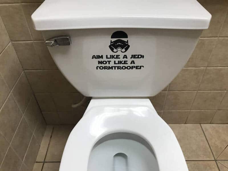 Toilet with a Star Wars Stormtrooper helmet decal and text.