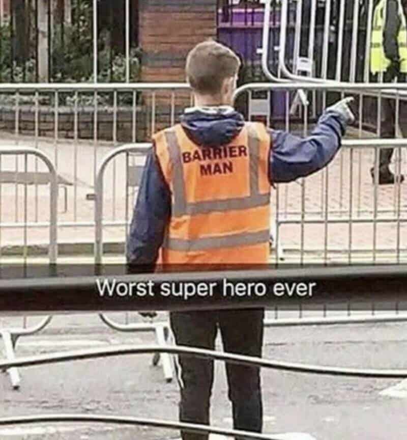 Child in a high-visibility vest labeled 'BARRIER MAN' pointing at something.