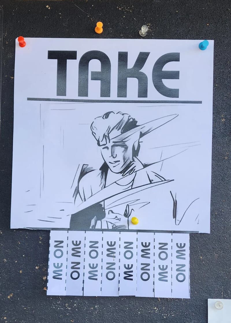Take sign with a drawing of a person and 'On Me' notes below.