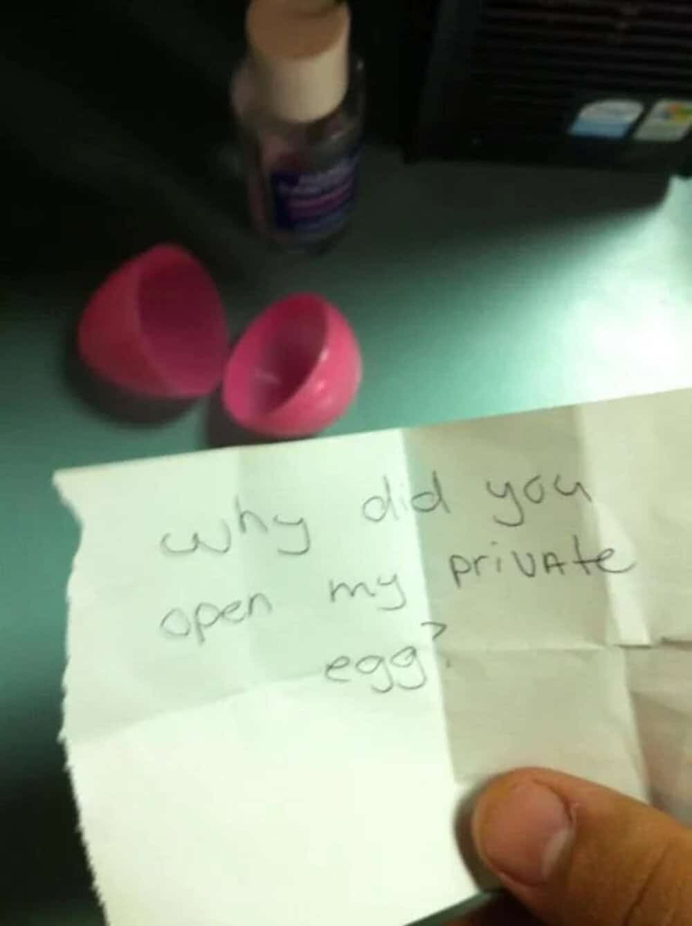 Note asking, 'why did you open my private egg?' with a hand holding a paper.