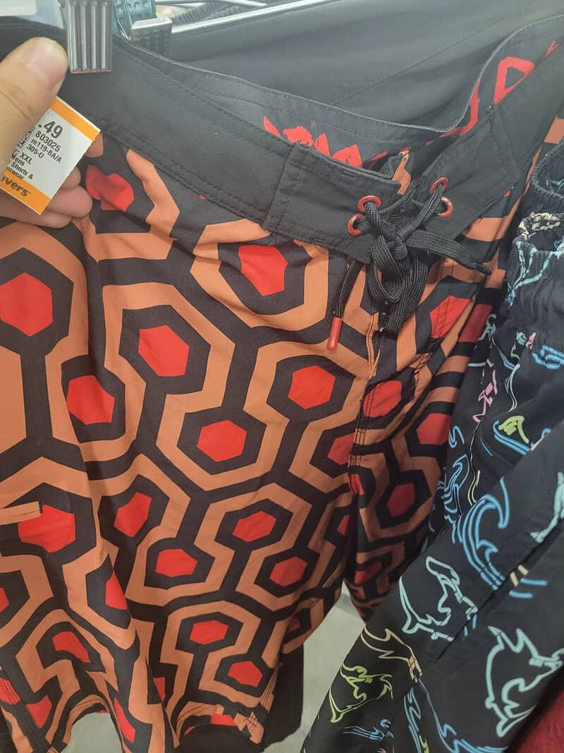 Close-up of patterned swim trunks with a drawstring, in a store.