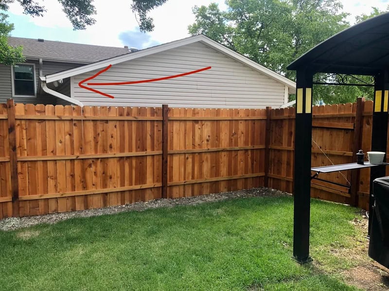 Leaning house roof with red arrow pointing to the left.