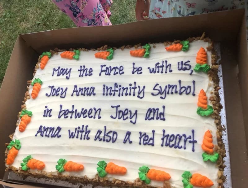 Cake with Star Wars message and orange carrots decoration.