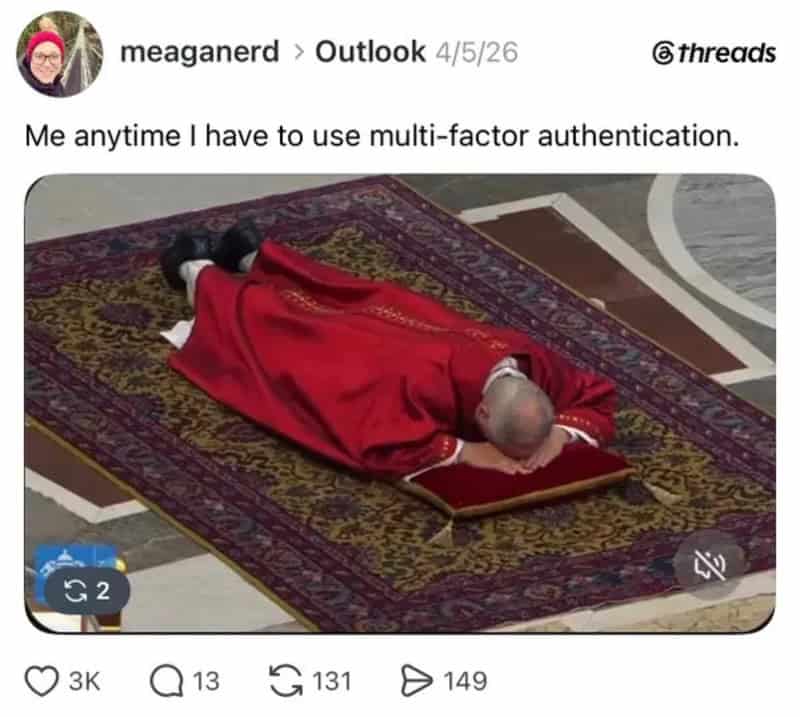 Person lying on a prayer rug, covered with a red cloth, in a prayer position.
