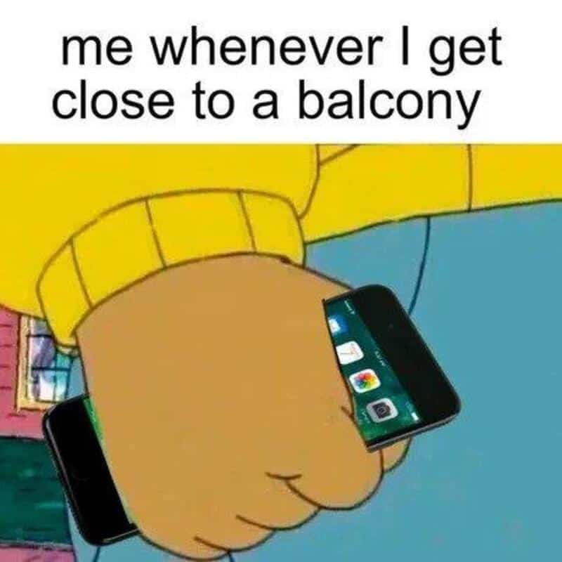Cartoon hand holding a phone with a balcony in the background.