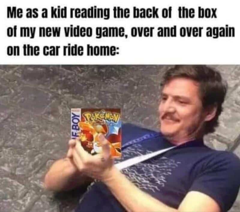 Man lying on the ground reading a Pokémon game box.