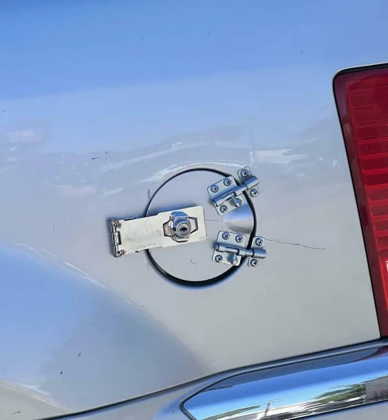 Hatchback trunk with makeshift latch using metal parts and a bolt.