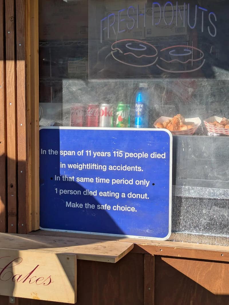 Sign with safety message about donut eating and weightlifting accidents.