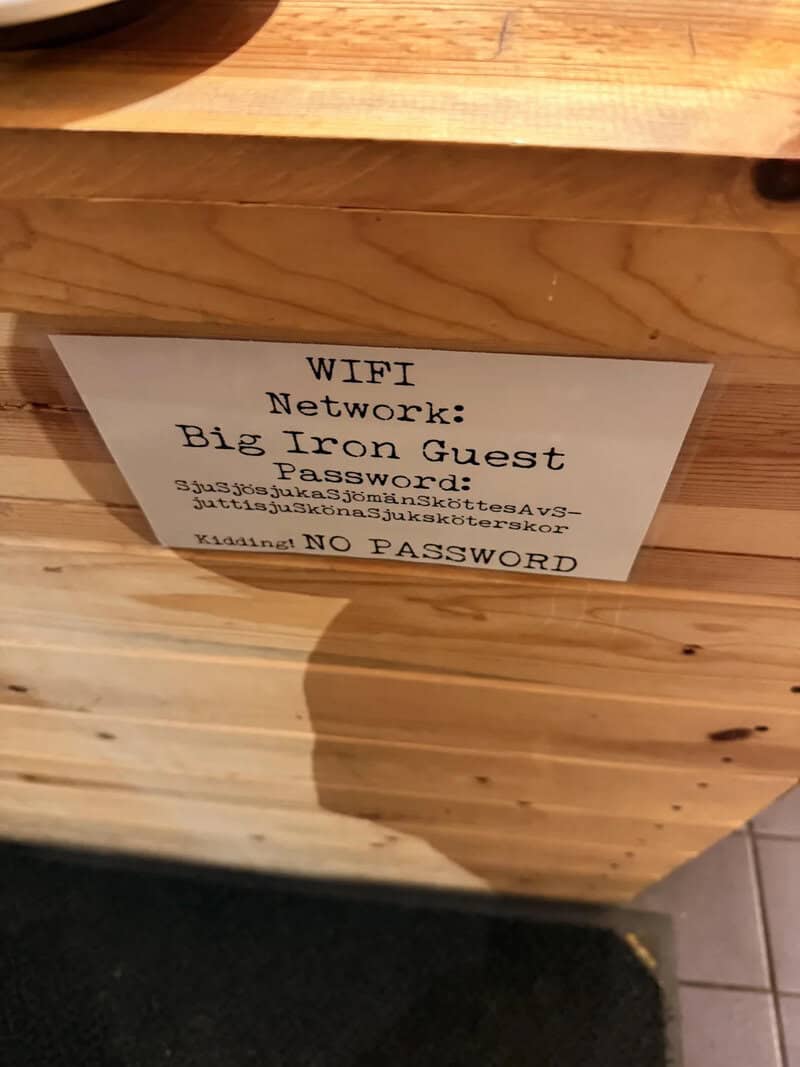 WiFi network info: Big Iron Guest, no password, handwritten sign on wood.