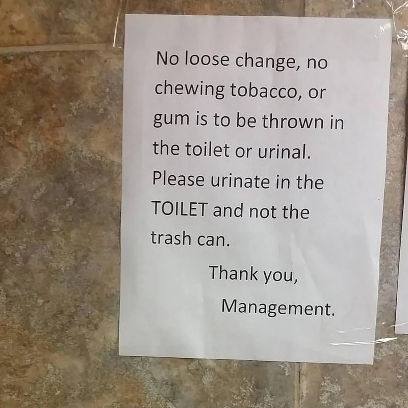 Sign with rules about not throwing gum or tobacco in the toilet or trash.