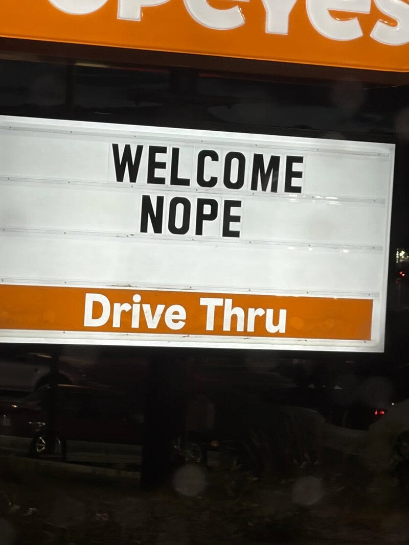 Welcome Nope Drive Thru sign at a fast food restaurant.