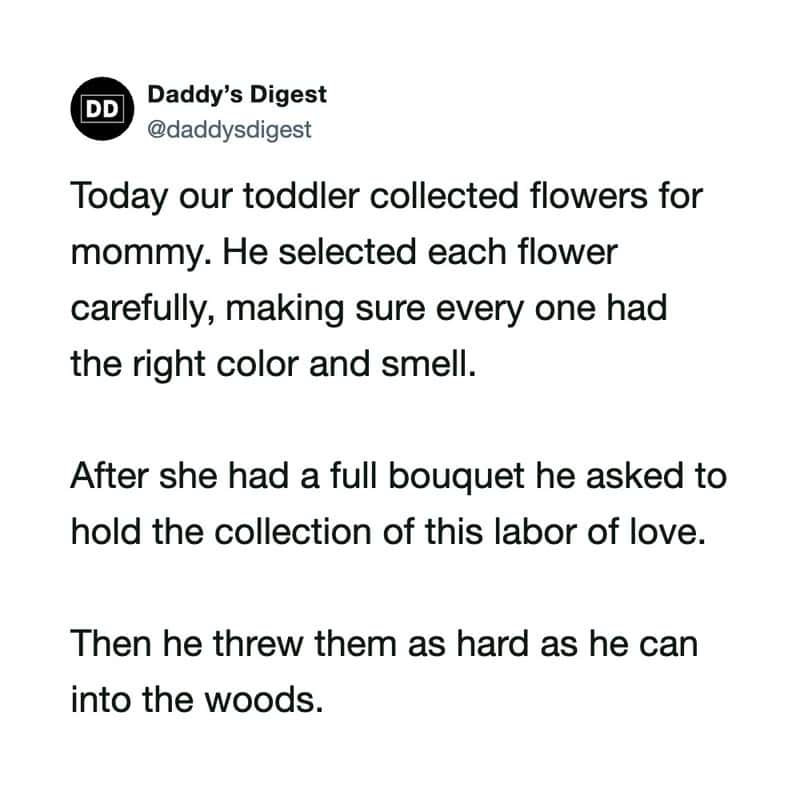 Toddler collecting flowers for mommy, carefully choosing each one.