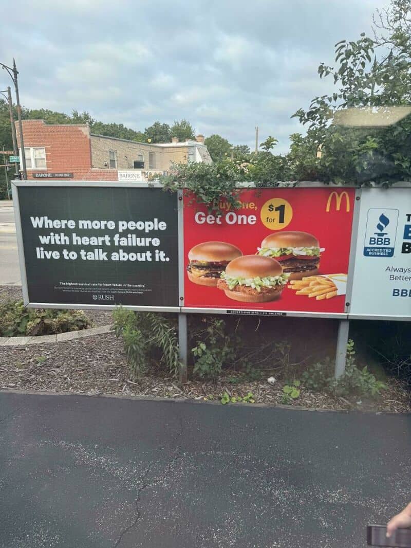 Billboard with a McDonald's ad for $1 burgers and a health warning sign about heart failure.