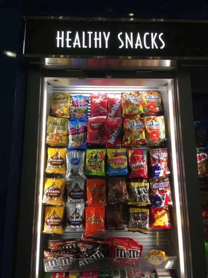 Vending machine labeled 'Healthy Snacks' filled with candy and chocolate bars.