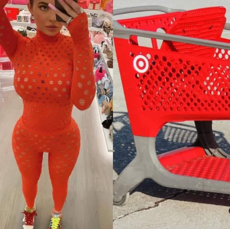 Woman in orange perforated outfit taking mirror selfie, shopping cart nearby.