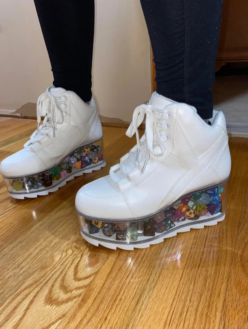 White sneakers with clear platform heels filled with colorful toy figures.