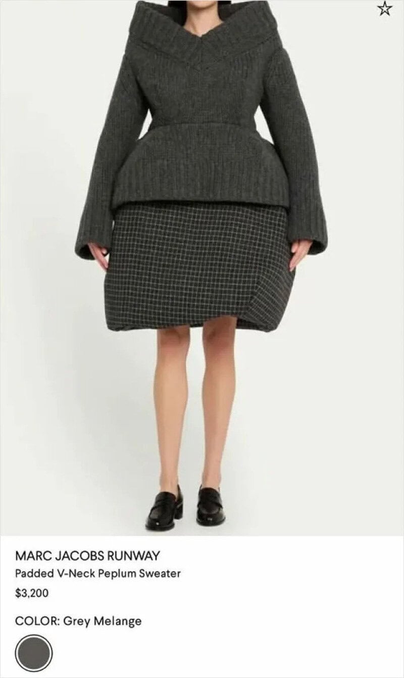 Fashion model wearing a padded V-neck peplum sweater and checkered skirt.