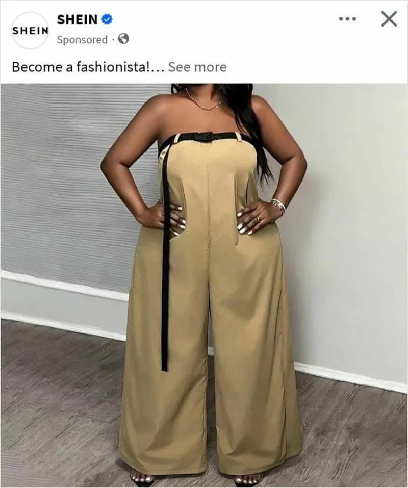 Woman in beige wide-leg jumpsuit with black strap and zipper detail.