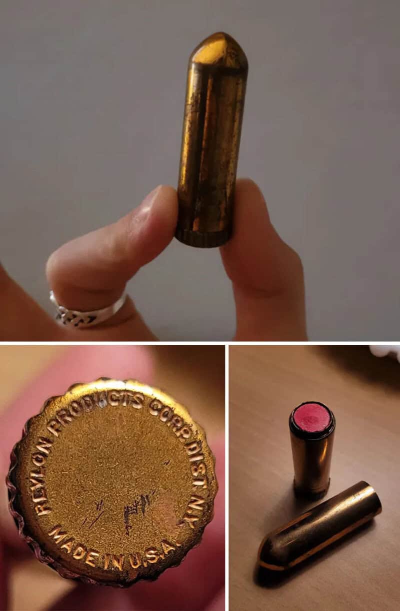 Close-up of a hand holding a bullet-shaped object with a gold finish.