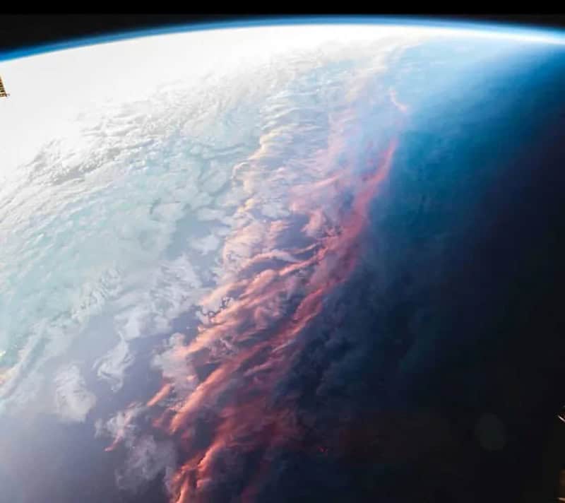 View of Earth from space showing clouds and atmosphere.