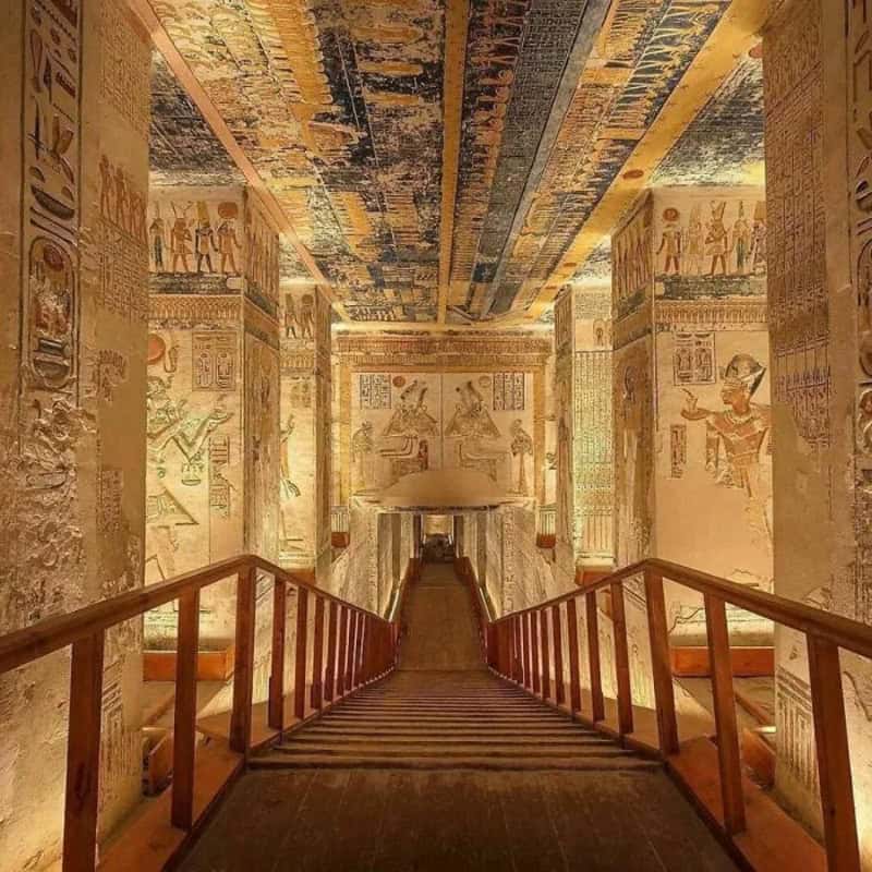 Ancient Egyptian tomb interior with hieroglyphs and wall paintings.