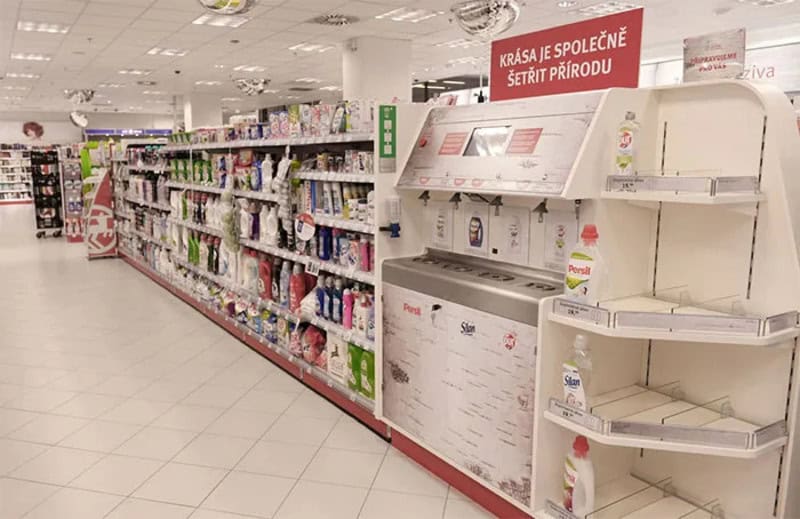 Empty store shelf with a sign in a supermarket, no products displayed.