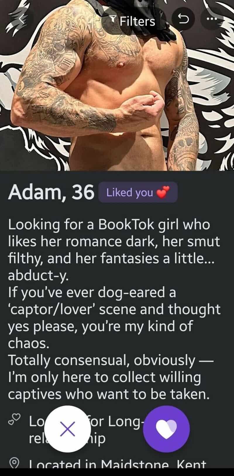 Adam, 36, with tattoos, flexing his arm, looking for a romantic partner.