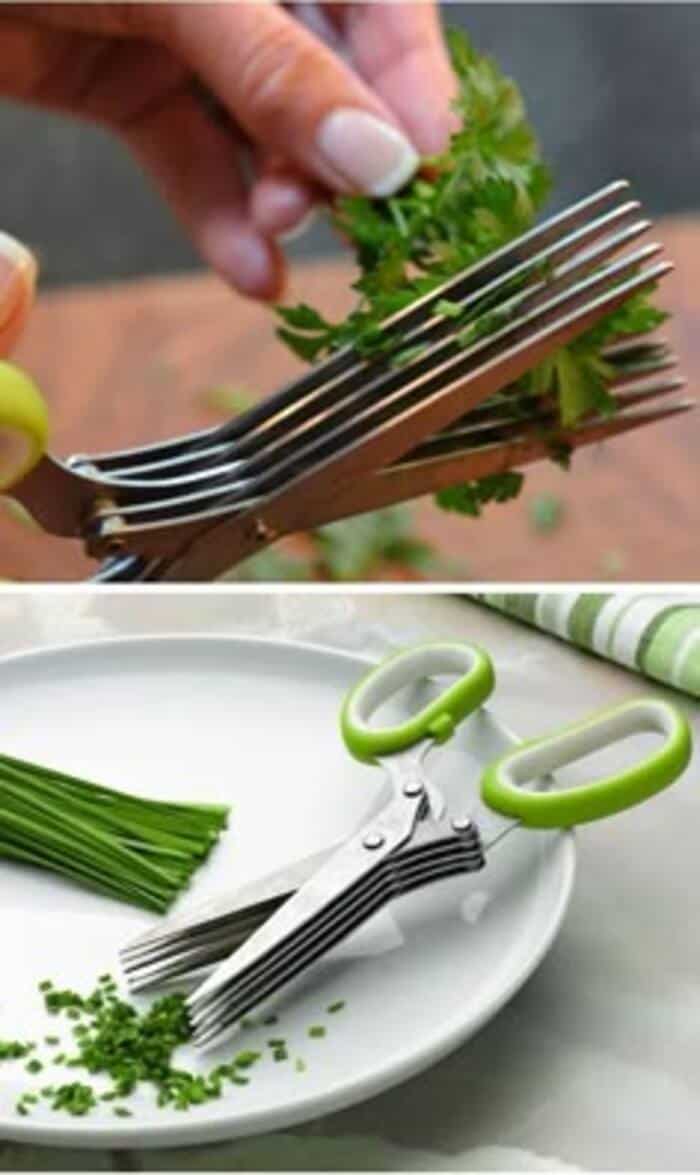 Multi-purpose kitchen scissors with green and white handles cutting herbs.