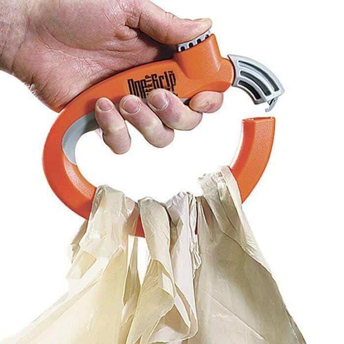 Hand holding a tissue dispenser with tissues hanging out, labeled 'One-Stop'.