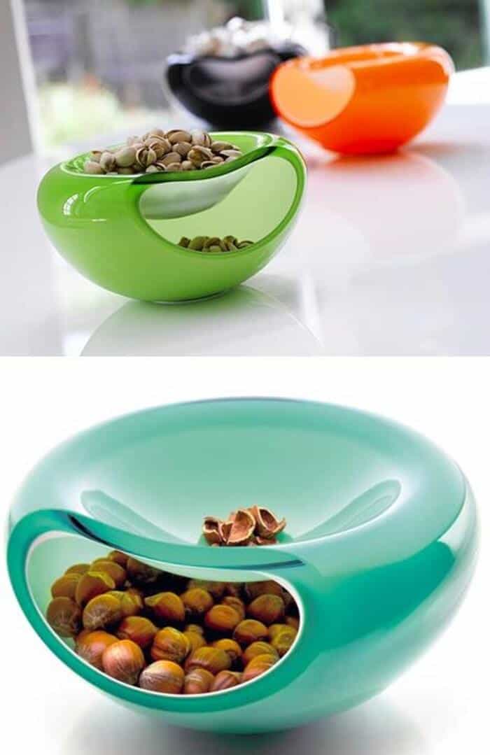 Colorful nut bowls with nuts inside, green, orange, and blue.