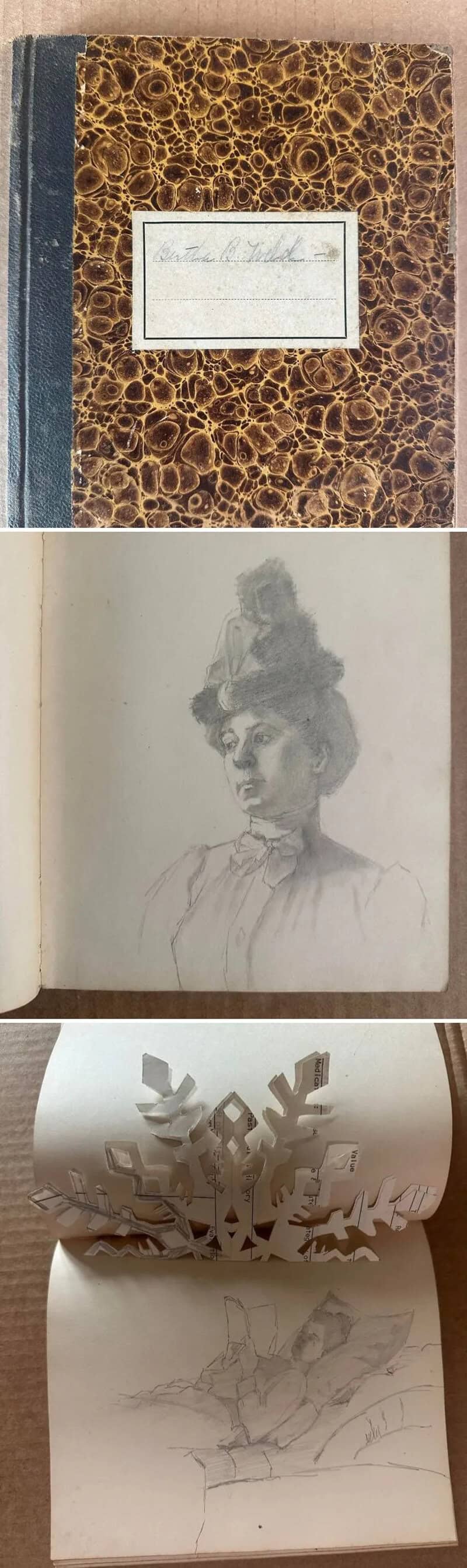 Vintage notebook with marbled cover and handwritten label, sketches of a woman and paper cutouts.