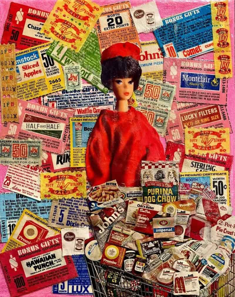 Vintage doll surrounded by colorful coupon and advertisement paper scraps.