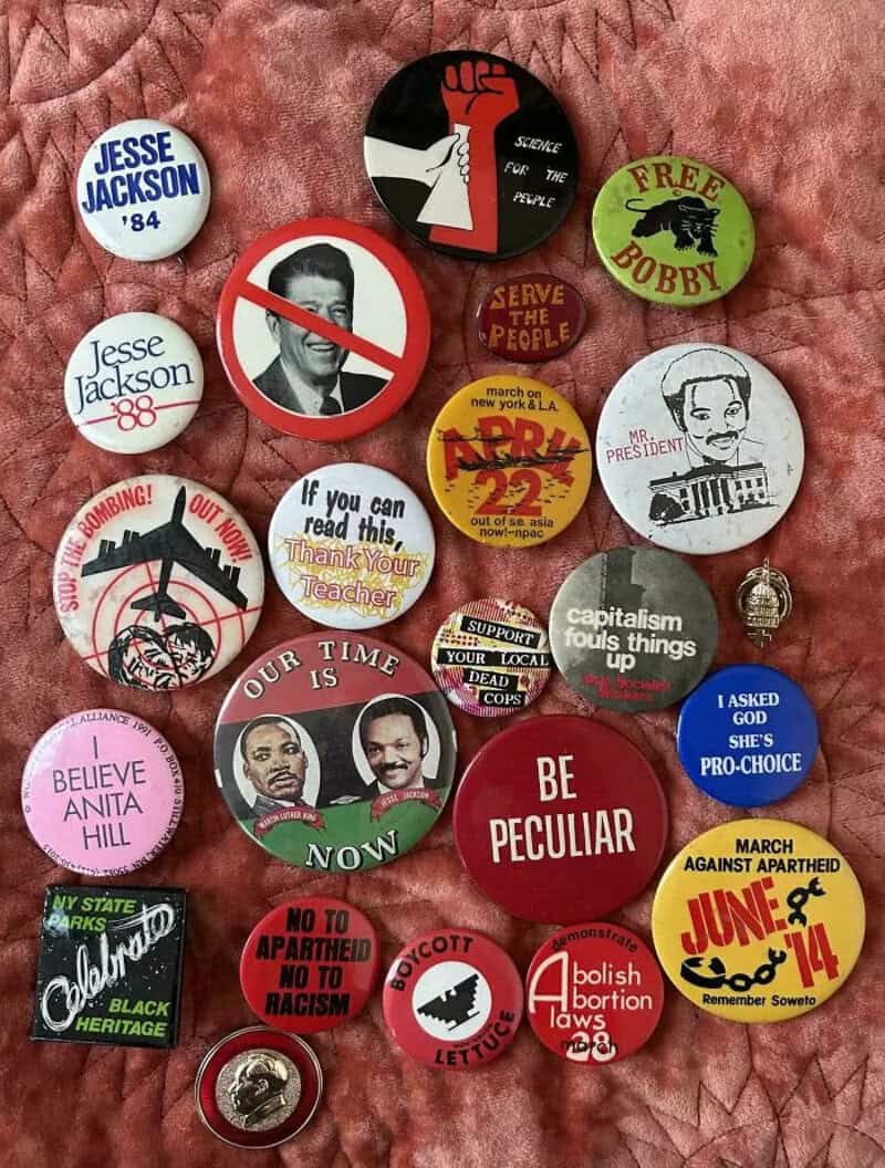 Collection of political and social buttons with various messages and images.
