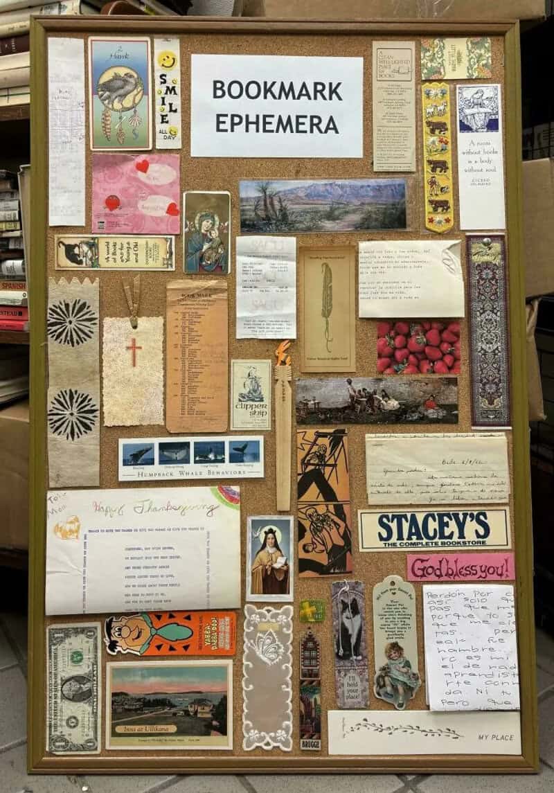 Collection of various bookmarks and ephemera on a display board.