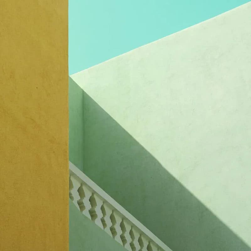 Minimalist building with colorful walls and shadow play, part of minimalist-photography-awards-2026.