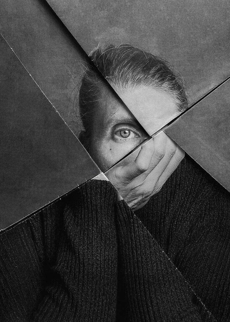 Black and white photo of a woman with one eye visible through geometric shapes.