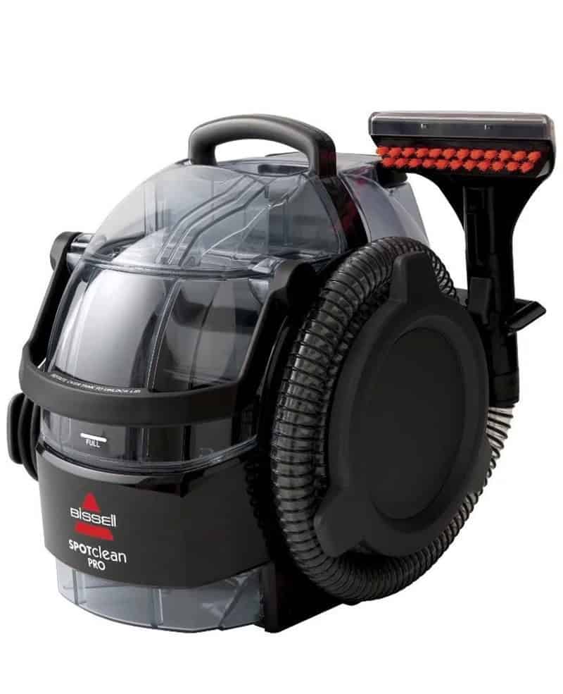 Image of a Bissell SpotClean Pro portable carpet cleaner with a transparent water tank.
