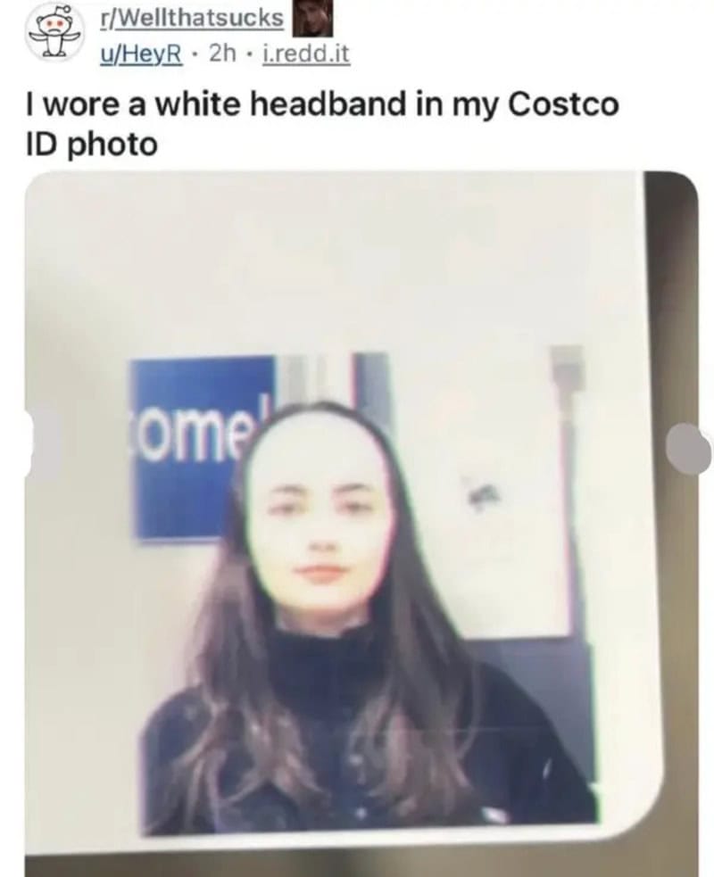 Woman with a white headband at Costco, blurry background.