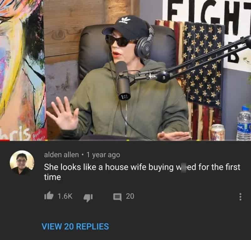 Woman wearing sunglasses and headphones speaking into a microphone in a podcast studio.