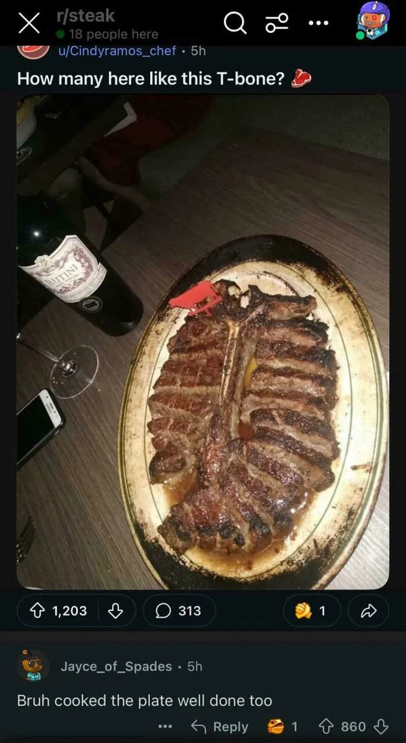 A large grilled T-bone steak on a plate with a bottle of wine and a glass nearby.