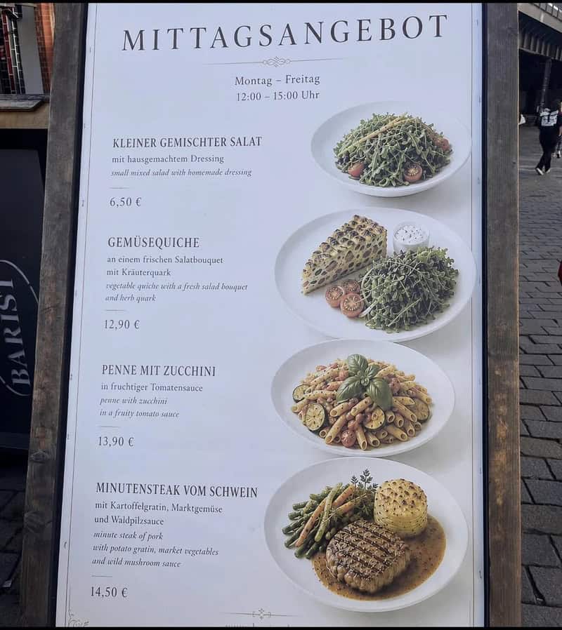 Menu board with four dishes and prices, titled 'Mittagsangebot' for Monday to Friday 12-15 Uhr.
