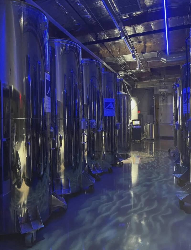 Industrial room with large shiny metal tanks and blue lighting, titled oddly terrifying.