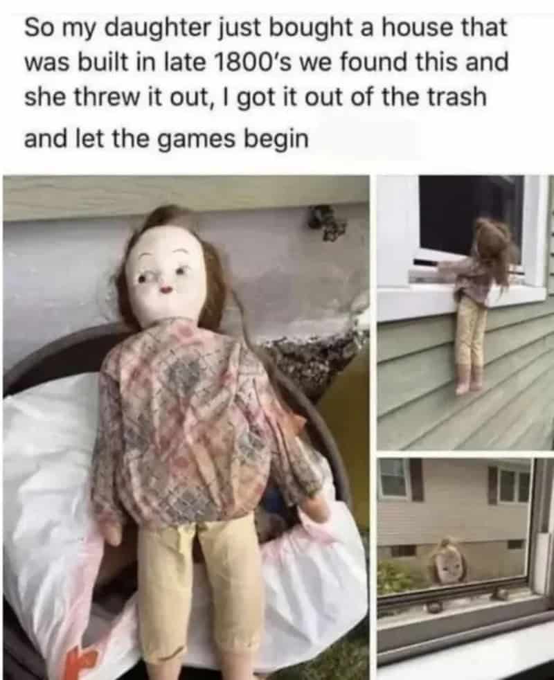 Child's doll with red hair and beige clothes, looking out the window.