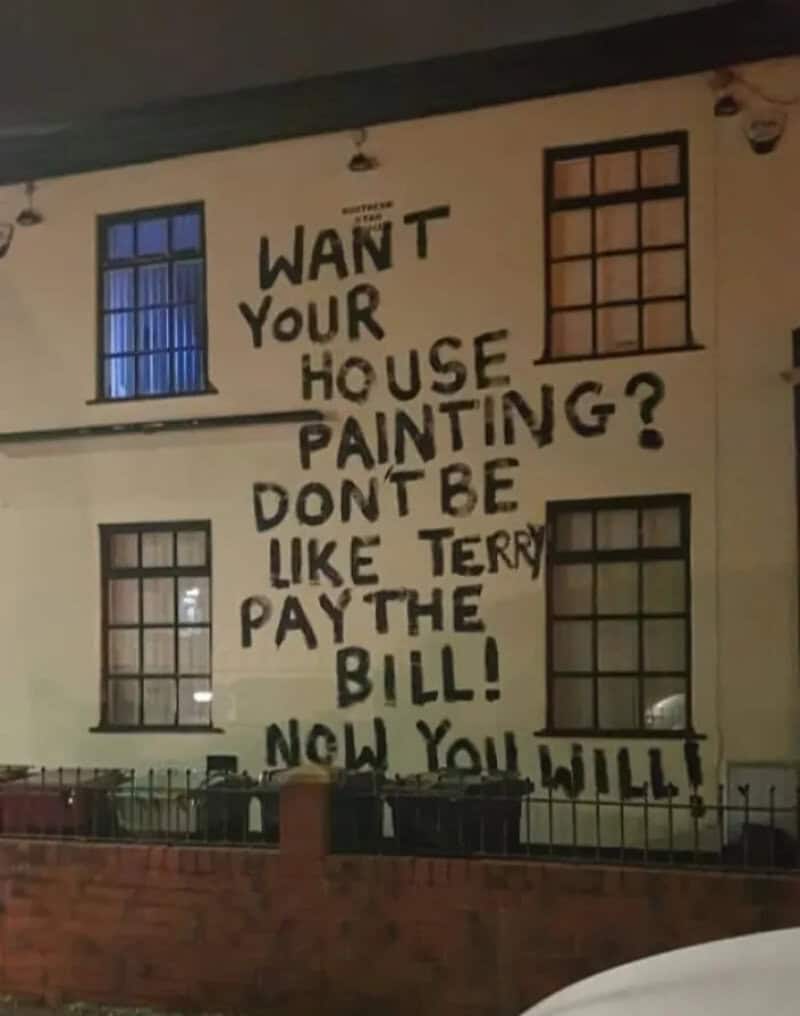 Large graffiti on house wall says 'Want your house painting? Don't be like Terry pay the bill! Now,你.