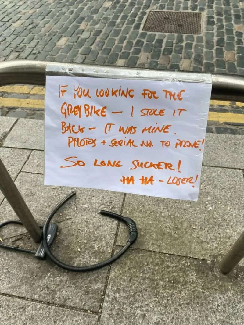 Sign claiming ownership of a grey bike stolen by someone else.