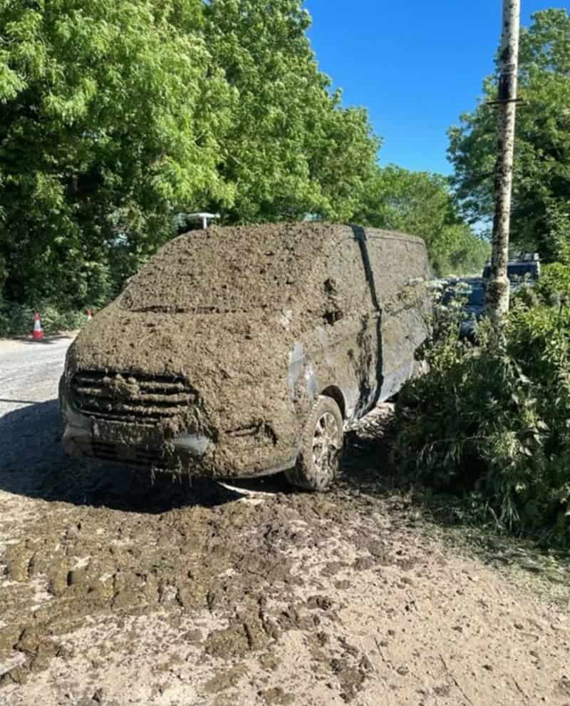Van covered in mud after driving through a muddy area.