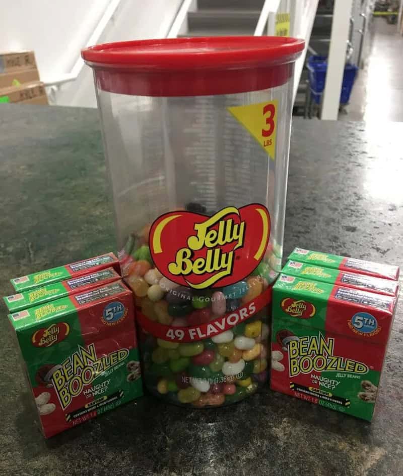 Jelly Belly jar with 49 flavors and two BeanBoozled boxes on a counter.