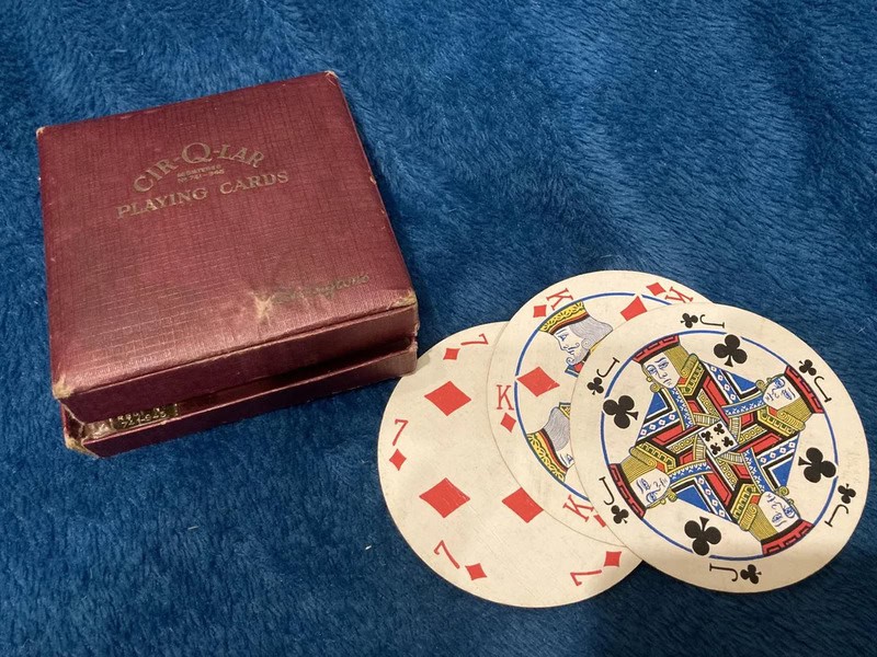 Vintage Cit-Q-Lar playing cards box with three cards on blue fabric.